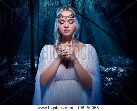 Young elven girl in night forest