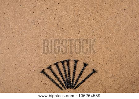 Iron screws on fibreboard