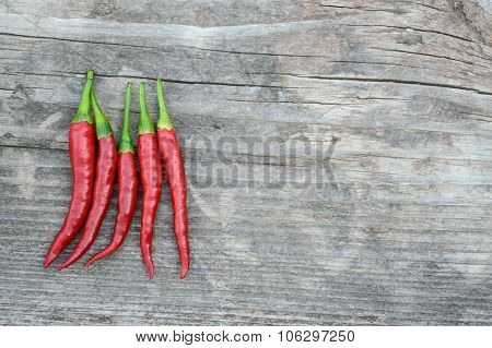 Hot Peppers On The Old Gray Wooden Board