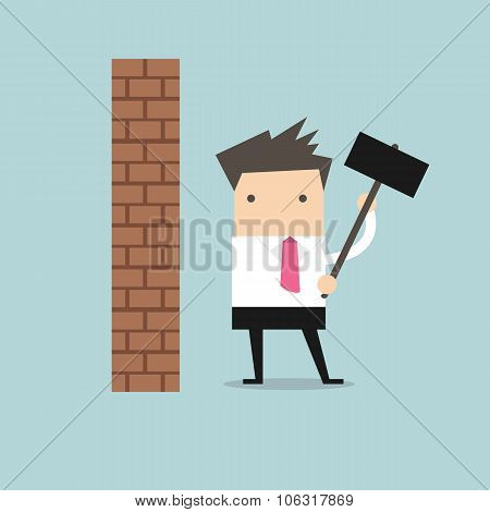 Businessman breaking wall with hammer