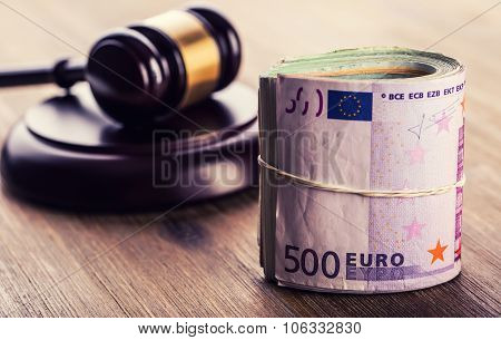 Judge's hammer gavel. Justice and euro money. Euro currency. Court gavel and rolled Euro banknotes.