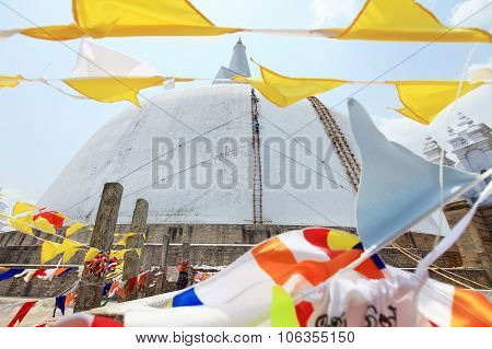 Anuradhapura dagoba with flags in  Ruvanvelisaya Sri Lanka