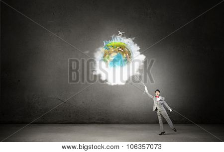 Businessman catch Earth planet with rope . Elements of this image are furnished by NASA