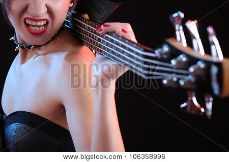 Fashion girl with guitar playing rock