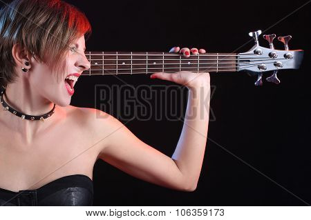 Fashion girl with guitar playing rock