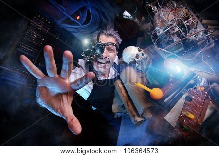 Portrait of a crazy medieval scientist working in his laboratory. Alchemist. Halloween.