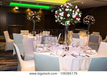 Wedding Banquet  Hall In Shades Of White With  Beautiful Flowers In Vases