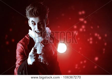 Bewitching handsome male vampire. Halloween. Dracula costume.