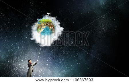 Businessman catch Earth planet with rope . Elements of this image are furnished by NASA