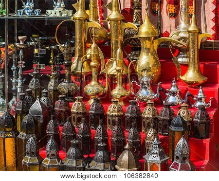 Row Of Shiny Traditional Coffee Pots And Lamp