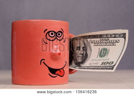 Cup with dollars money in the hand