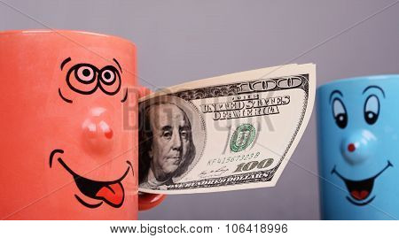 Cup with dollars money in the hand