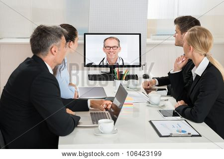 Businesspeople Videoconferencing With Doctors