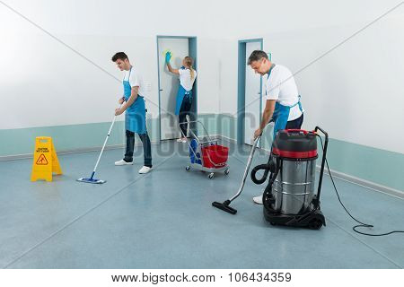 Janitors Cleaning Corridor