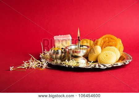 Beautifully Decorated Pooja Thali for diwali celebration to worship , having Indian sweets, silver l