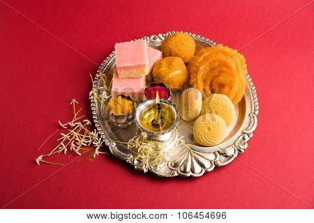Beautifully Decorated Pooja Thali for diwali celebration to worship , having Indian sweets, silver l