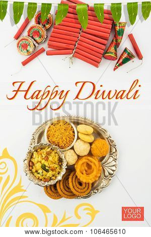 Diwali snacks with Diwali fire crackers in silver plate isolated on red background