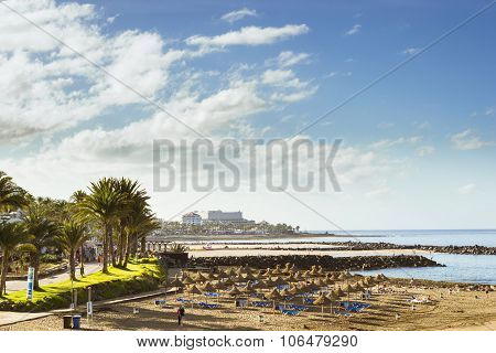 Straw Umbrellas And Loungers On The Beach Costa Adeje, Tenerife