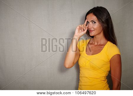 Pensive Woman Remembering With Finger Raised