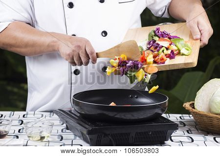 Chef Putting Vegetable To The Pan