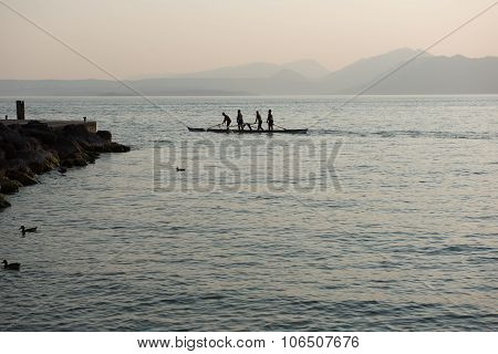 Four Rowers Rowing A Boat Standing