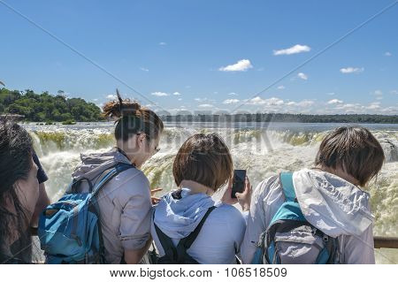 Tourists Taking Photos Of Devil Throat At Iguazu Park