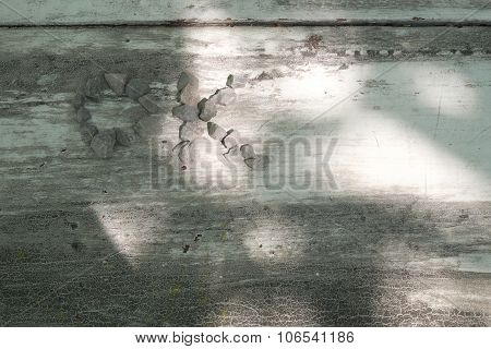 White wooden background with black marks and hole line, formed stones in wording of ok with sunshine