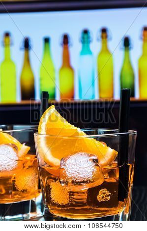 Detail Of Two Glasses Of Spritz Aperitif Aperol Cocktail With Orange Slices And Ice Cubes On Bar Tab
