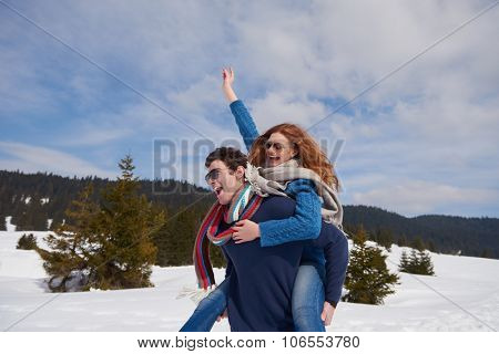 romantic winter  scene, happy young couple having fun on fresh show on winter vacatio, mountain nature landscape