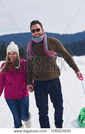 romantic winter  scene, happy young couple having fun on fresh show on winter vacatio, mountain nature landscape