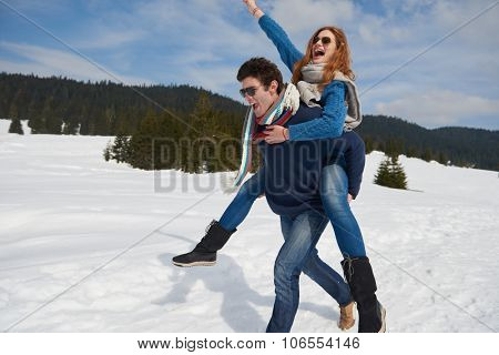 romantic winter  scene, happy young couple having fun on fresh show on winter vacatio, mountain nature landscape