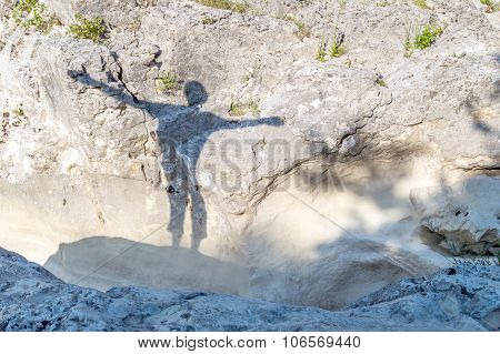 Silhouette Of A Happy Person Outdoor On The Rocks, With His Arms Spread