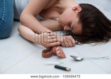 Desperate girl lying on the floor
