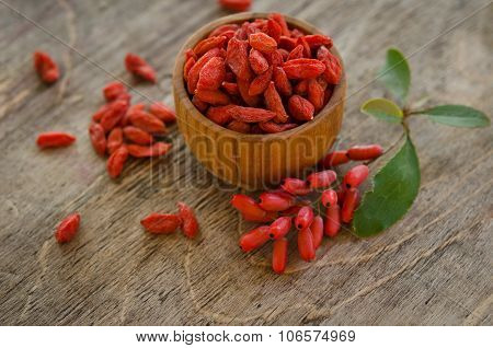 Barberries And Goji Berries On Wooden Background
