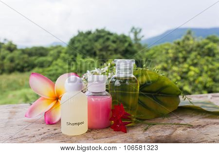Mini set shampoo or bath gel on nature green background