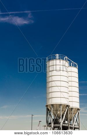 Metal Silos Against Blue Sky