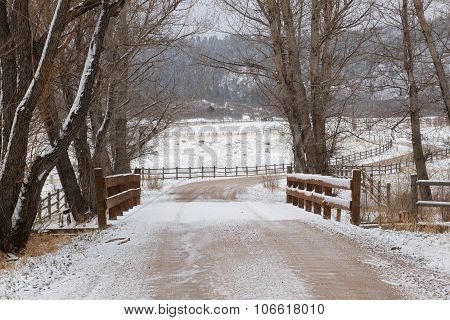 Snowy Road Crossing a Bridge