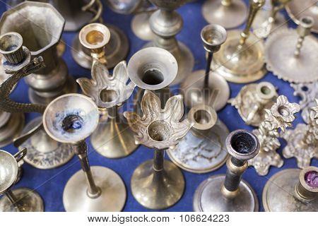 Many Old Silver Candle-stands On A Flea Market