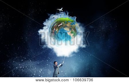 Businessman catch Earth planet with rope . Elements of this image are furnished by NASA