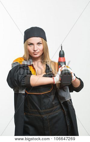 Young sexy female holding a cordless screwdriver