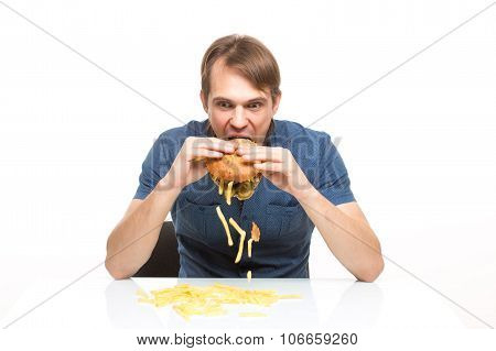 man is not careful eating tasteless burger.
