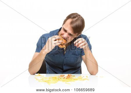 man is not careful eating tasteless burger.
