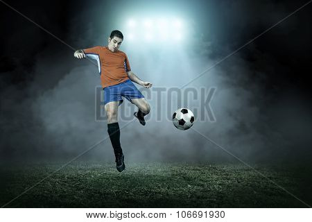 Soccer player with ball in action outdoors