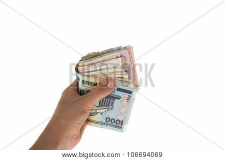 Banknotes from different countries in the hand folded in half