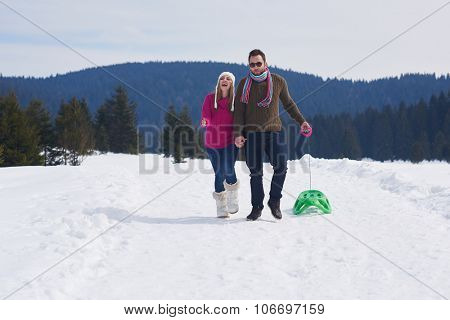 romantic winter  scene, happy young couple having fun on fresh show on winter vacatio, mountain nature landscape
