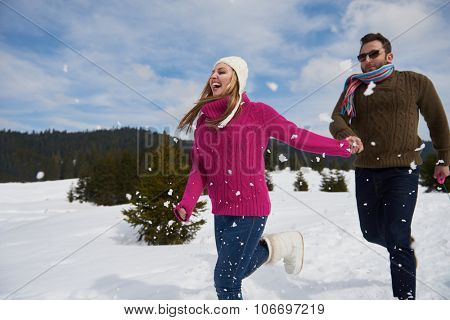 romantic winter  scene, happy young couple having fun on fresh show on winter vacatio, mountain nature landscape