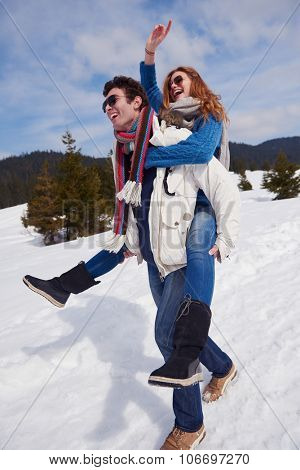 romantic winter  scene, happy young couple having fun on fresh show on winter vacatio, mountain nature landscape