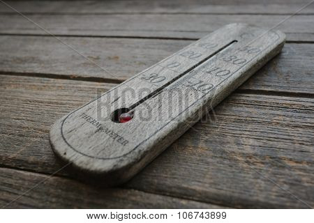 wood thermometer on old wood background