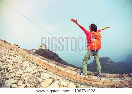 cheering hiking woman hiker open arms on chinese great wall