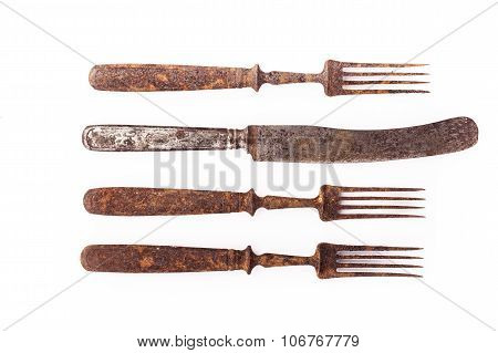 Rusty old fork and knife. Closeup isolated on white background